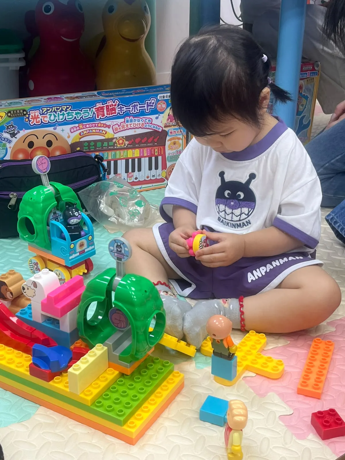 A young child exploring hands-on learning toys.
