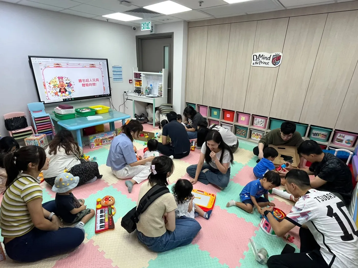 Parents and children sitting together at an interactive storytelling workshop.